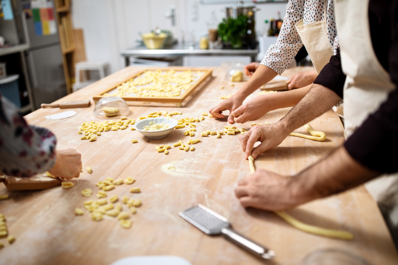 People at cooking workshop making fresh pasta