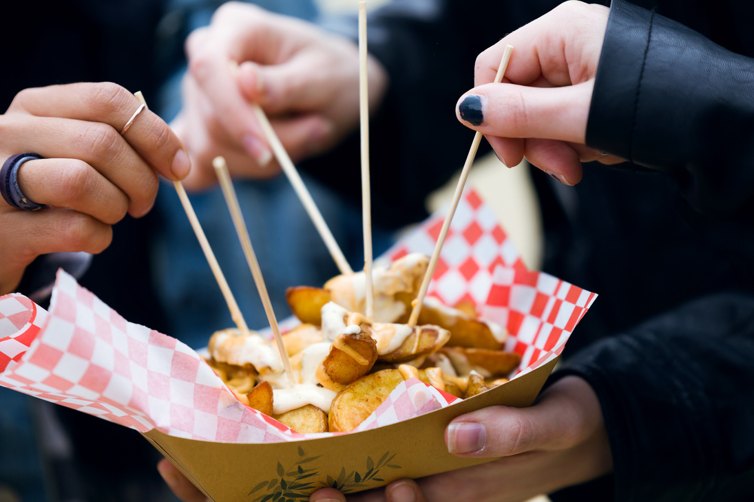 Group of Friends Visiting Eat Market and Eating Potatoes in the